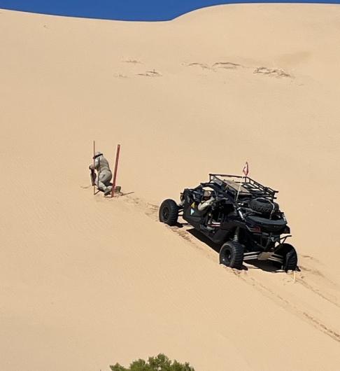 El Centro Park Ranger posts OHV closure signs in the dunes. 