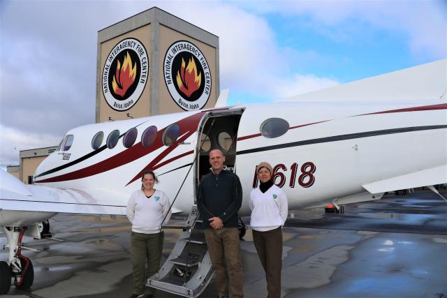 BLM Utah Curator and NAGPRA Coordinator Diana Barg (left) and Tribal Liaison Jessica Montcalm (right) with NAO Lead Plane Pilot Hans Germann (center) at National Interagency Fire Center, prepare for take-off from Boise, Idaho.