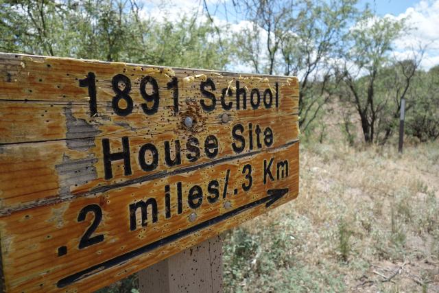 Sign points to the 1891 School House.