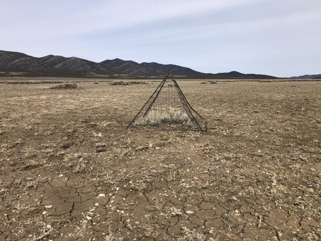 A utilization cage in the middle of barren ground.
