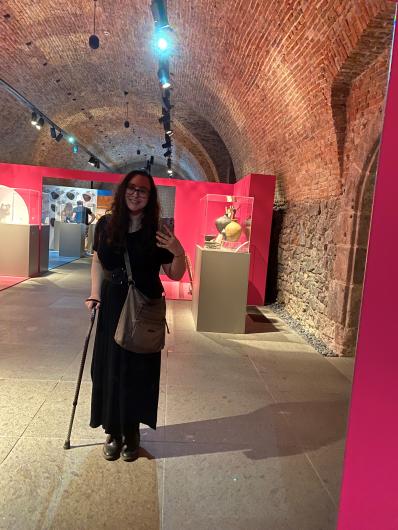 Kaitlin walking through a museum display