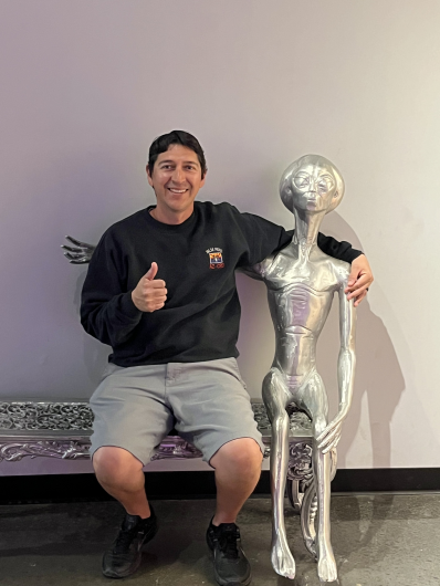 Luis Lopez posing with alien statue