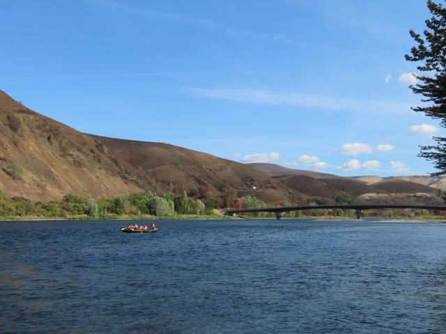 A raft of cadets practice paddling at the start of the trip, with the scorched canyon sides from the Gwen Fire in the background.