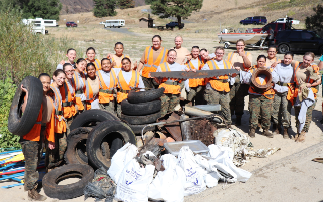 Cadets pose with all of the debris they retrieved from the river corridor.