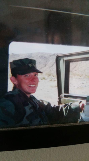 Annie in the driver's seat of military vehicle