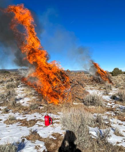 Firefighters with the Upper Colorado River Interagency Fire Management Unit monitor the scheduled burning of slash piles. (BLM photo)
