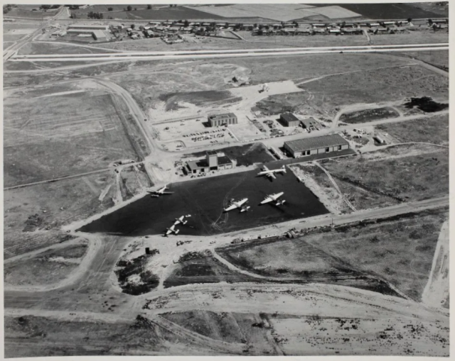 Vintage photo from above of a parking lot with airplanes and buildings surrounding