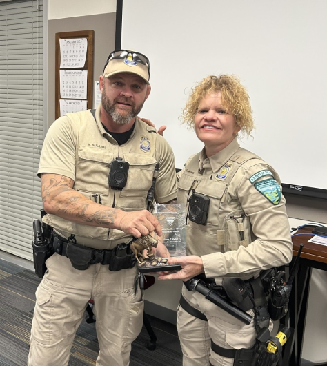 Supervisory ranger presents award to Ranger Carrie Wostal.
