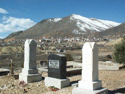 A cemetery in daytime with a mountain in the background