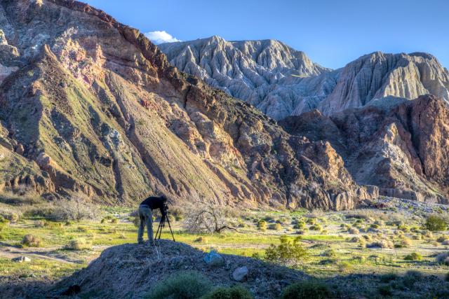 a man photographs a majestic mountain range