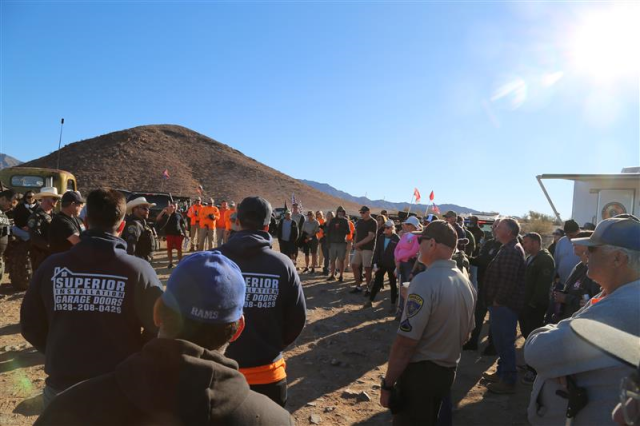 A large group of volunteers gather with LE officers for briefing.