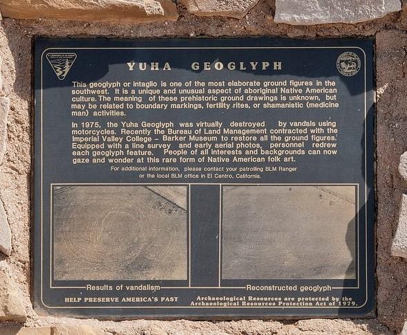 Photo shows a metal sign describing the Yuha Geoglyphs, one of the most elaborate ground figures in the southwest. It shows two photos comparing the vandalized and reconstructed geoglyph.
