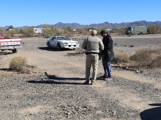 A Ranger is talking to a man. 