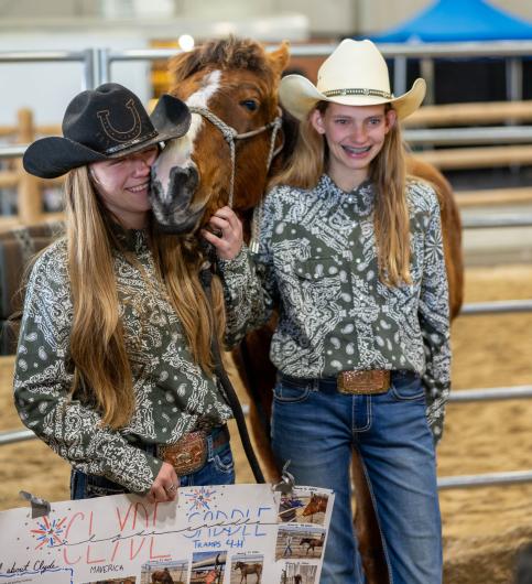 4-H youth smile as their young horse is adopted during the 2024 Idaho Horse Expo