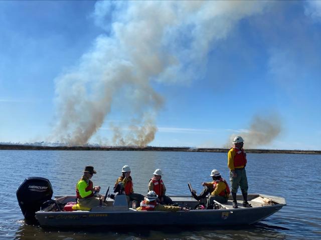 BLM and U.S. Fish and Wildlife Service staff observe the prescribed burn 