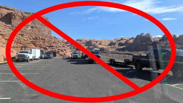 Several trucks and trailers occupy multiple spots in a parking lot