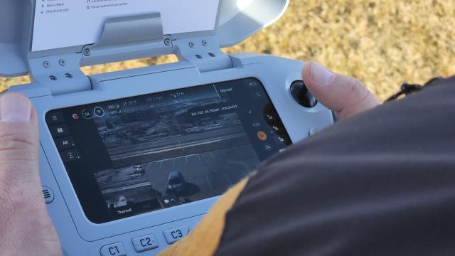 A close up of a pilot using an uncrewed aircraft controller.