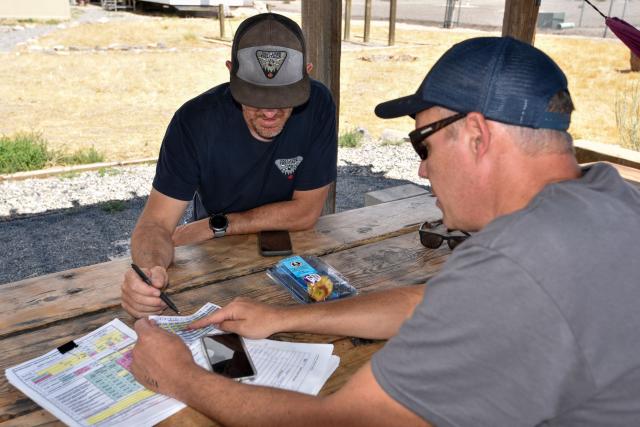 Austin and Dr. Drew carefully calculate weight, fuel load, and environmental factors to confirm the helicopter is mission-ready for current weather conditions and flight plans. 