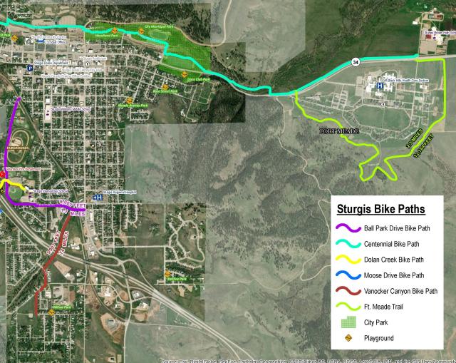 A satellite map showing the eastern part of the town of Sturgis, South Dakota, with different colors indicating the location of different trails or bike paths, including the Fort Meade trail in the upper right corner of the map. A key to the bike paths is in the lower right corner. Some of the paths have been cropped out.