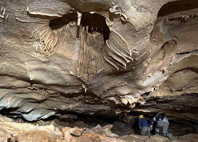 Two people explore a cave
