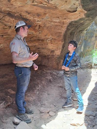 Shaw talks with Troop 8 scout, a young boy