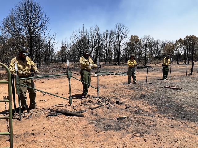 Wildland firefighters and other staff complete fence repair