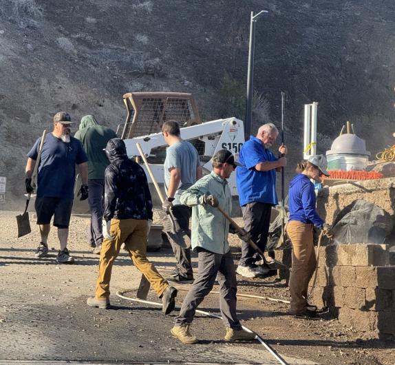 Workers stacking blocks in a retaining wall.