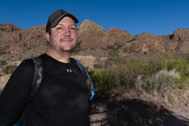 Archaeologist Garrett Leitermann wearing a cap on a sunny day.