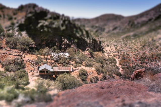 Various buildings in a canyon in the distance.