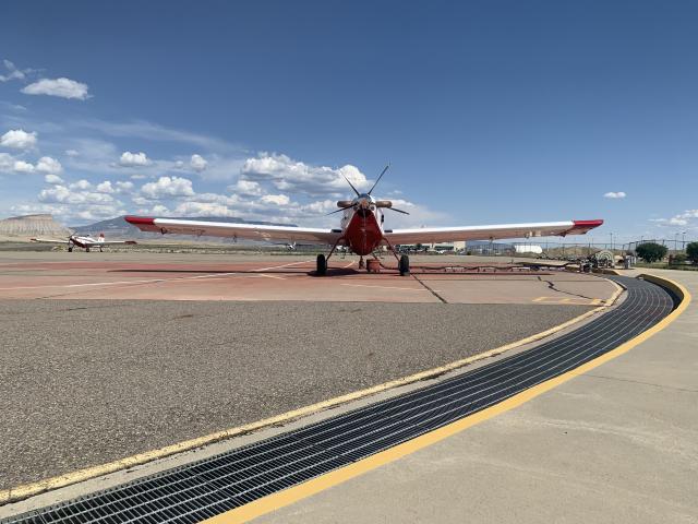 A propeller plane sitting on a tarmac.