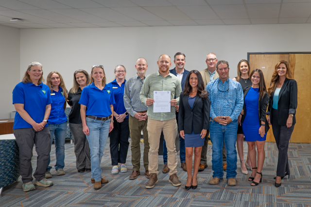 Attendees of an informal event to celebrate the public land sale of the Clifton Parcel from BLM to Mesa County pose for a group photo.