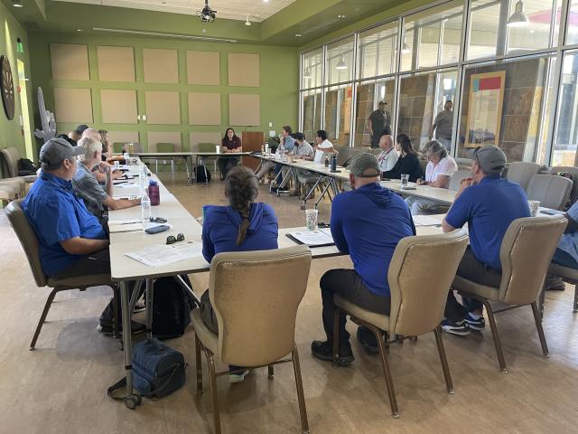 Tohono O’odham Nation Vice Chairwoman Carla Johnson welcomes the Bureau of Land Management. A group of people sit around a table.