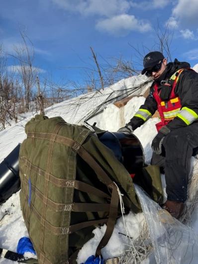 Figure 3: Environmental protection specialist Tony Gallagher unpacks a supply drop for emergency overflow prevention at a site in the McGrath area. Photo by Fred Transburg (BLM).