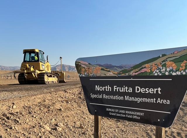 Construction equipment works on 18 Road paving operations in the North Fruita Desert