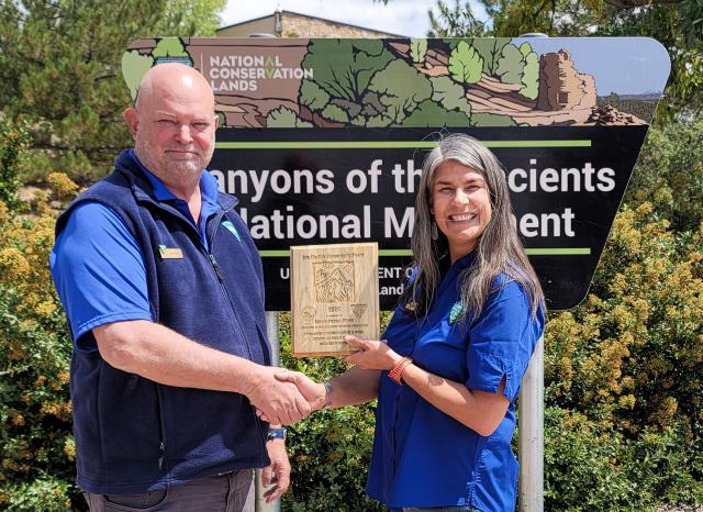 Amala Posey-Monk receives the Eric Finstick Stewardship Award from her manager, Ray O'Neil
