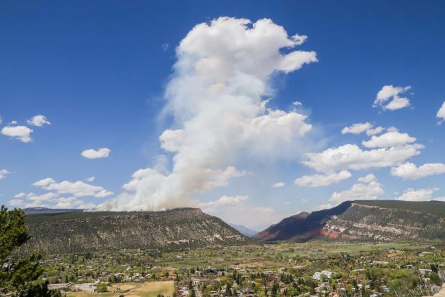 The shadow of the smoke plume from a prescribed fire on Animas City Mountain underscores its proximity to the town of Durango, Colo.