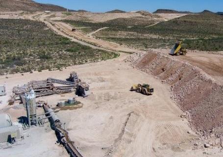A aerial shot of an open pit mine in the desert.