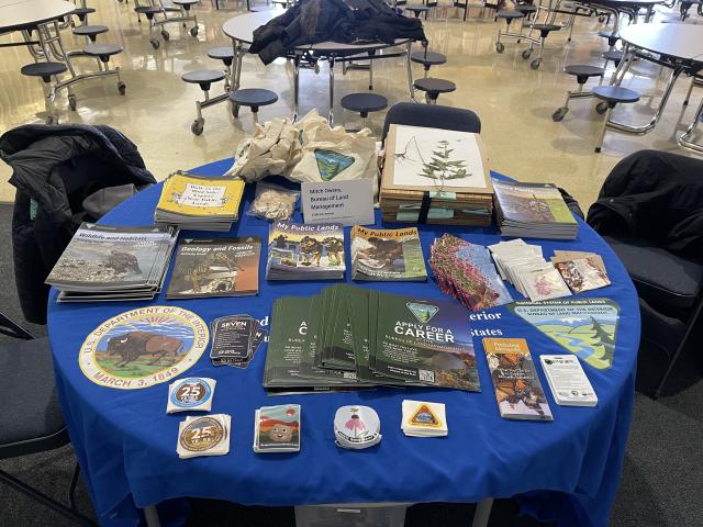 Table displaying various brochures, educational materials, and promotional items related to wildlife, geology, and public lands management.