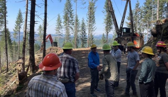 Barry Bushue meets with staff and purchaser at a timber sale in Coos Bay