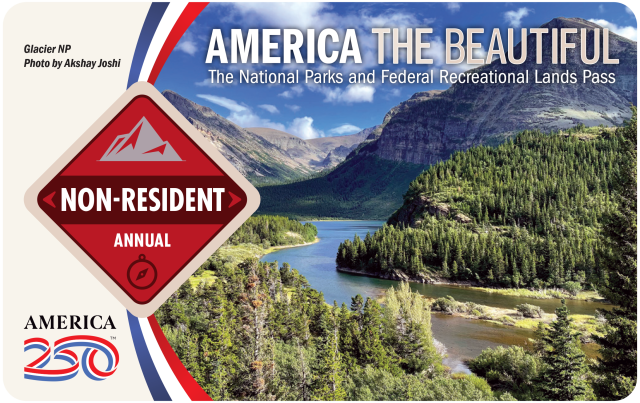 Front side of the 2026 America the Beautiful Pass for non-residents featuring mountains and a forest with a river running through it from Glacier Nation Park