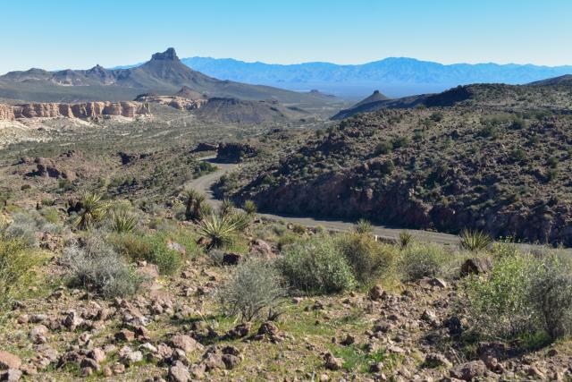 A narrow road winds through mountains