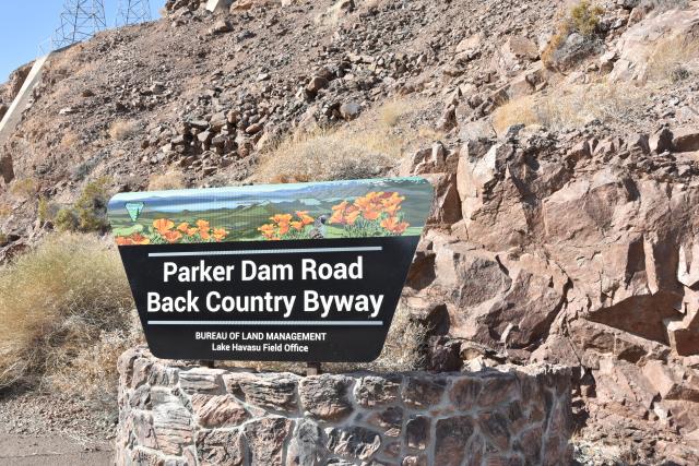 A sign for Parker Dam Road Back Country Byway on a sunny day