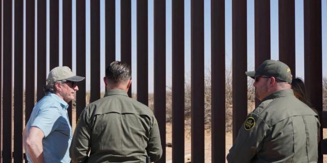 Secretary Burgum standing with border patrol at the southern border wall in New Mexico.