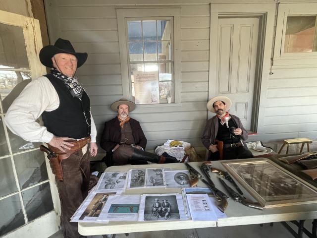 Three men dressed up as cowboys