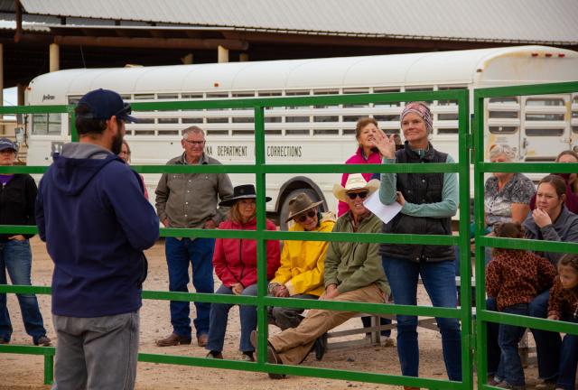 A woman raises her hand during an auction