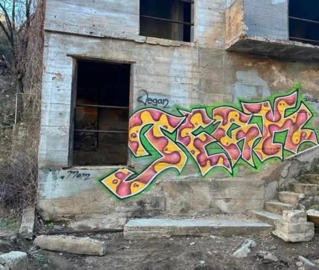 A wall covered with graffiti.