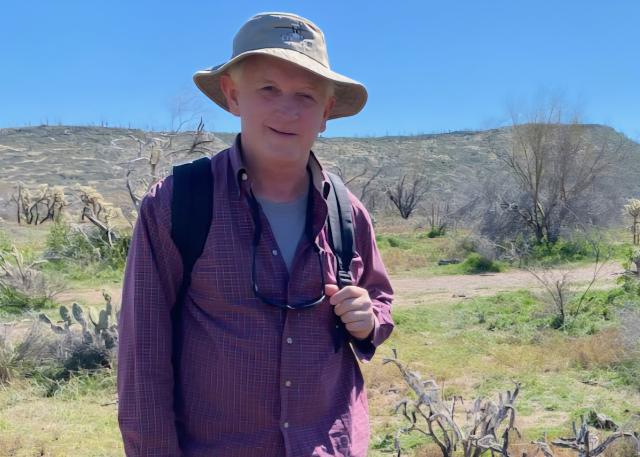 A man wears a wide-brimmed hat