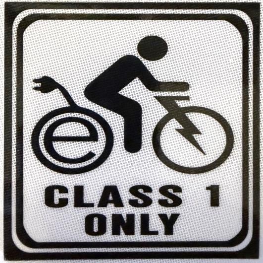 Class 1 only e-bike sticker, featuring a person on a bike with an E inside the back wheel, a charging cable and a lightening bolt for the bike fork