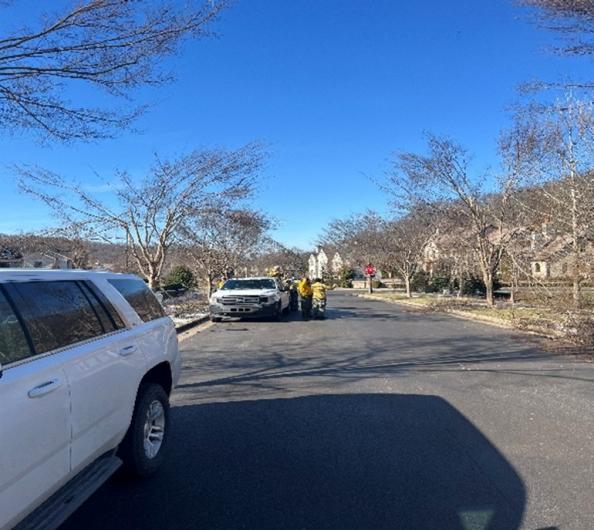 Firefighters getting geared up to assist with clearing branches and downed trees.