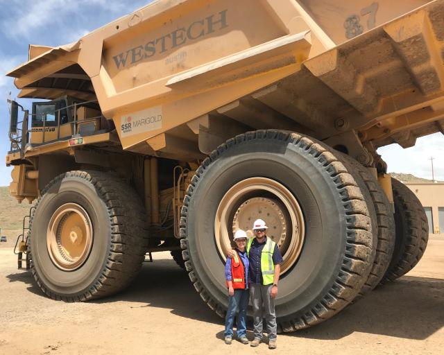 next to husband and huge vehicle